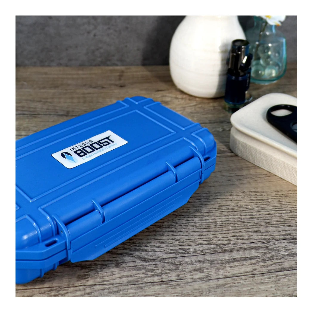 Integra Boost blue travel cigar case shown on a wooden table